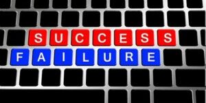success and failure written on a keyboard